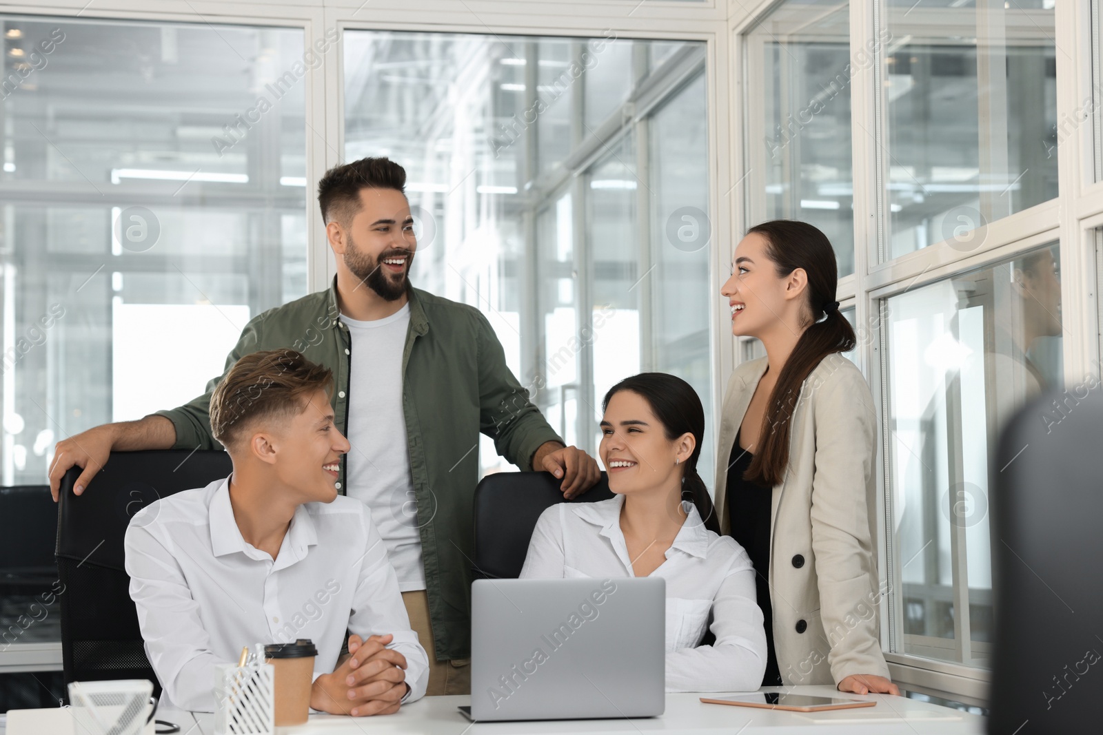 Photo of Colleagues working together in open plan office