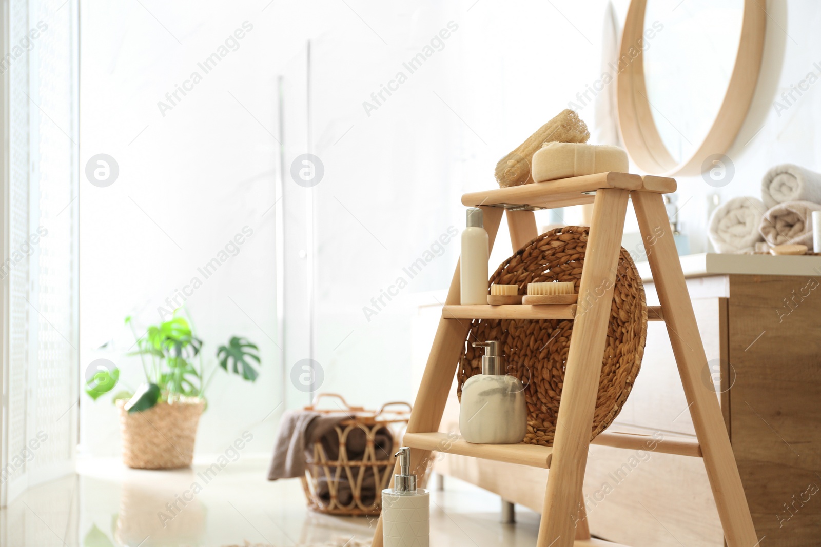 Photo of Dispensers and different toiletries on decorative ladder in bathroom. Idea for interior design