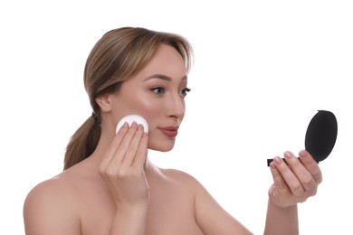 Photo of Beautiful young woman applying face powder with puff applicator on white background