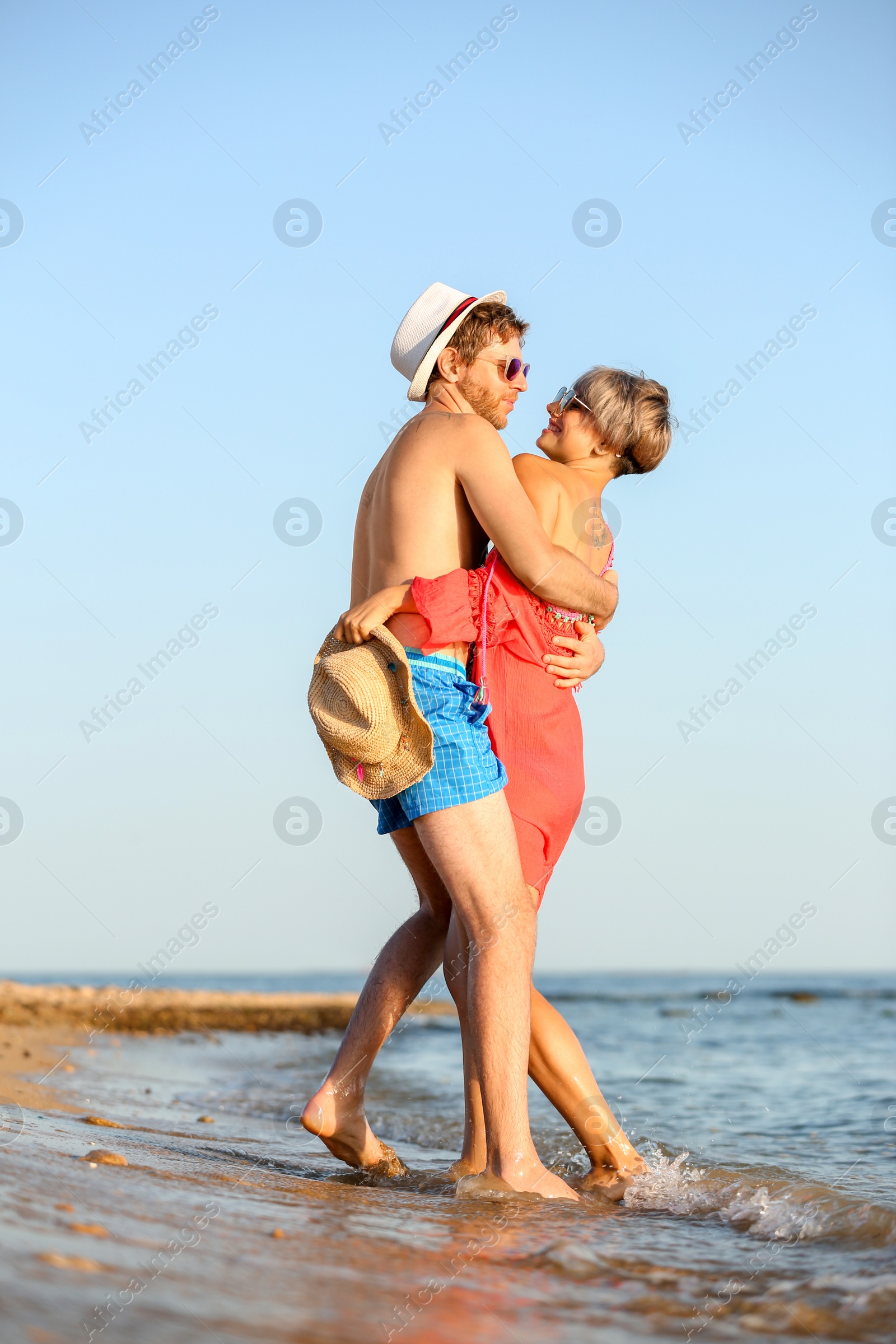 Photo of Happy young couple near water on beach
