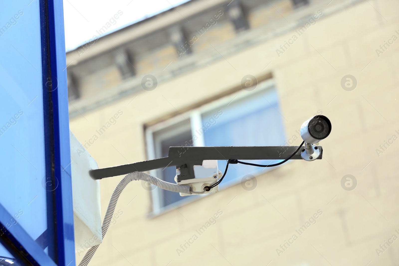 Photo of Modern security CCTV camera on wall outdoors