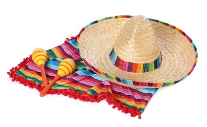 Photo of Mexican sombrero hat, maracas and colorful poncho isolated on white