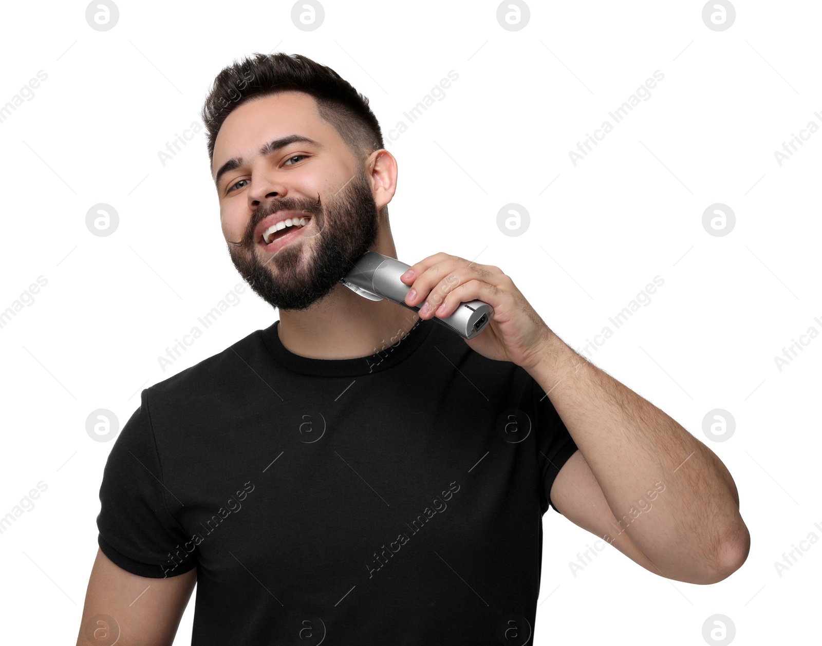 Photo of Handsome young man trimming beard on white background