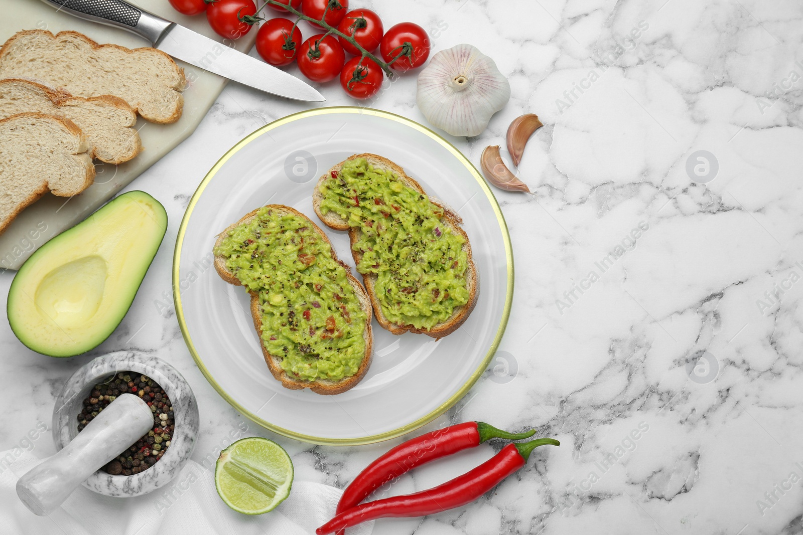 Photo of Delicious sandwiches with guacamole and ingredients on white marble table, flat lay. Space for text