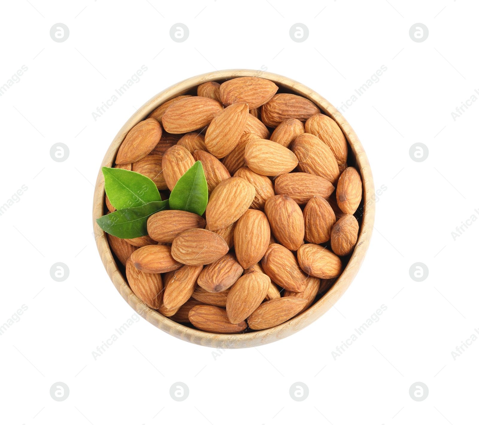 Photo of Bowl with organic almond nuts and green leaves on white background, top view. Healthy snack