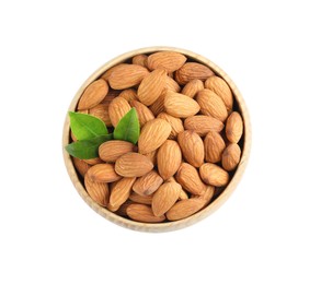 Photo of Bowl with organic almond nuts and green leaves on white background, top view. Healthy snack