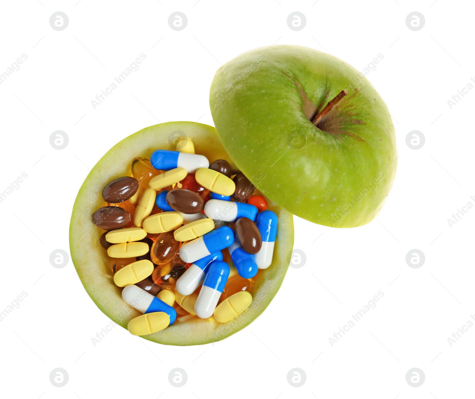 Photo of Cut apple full of weight loss pills on white background, top view