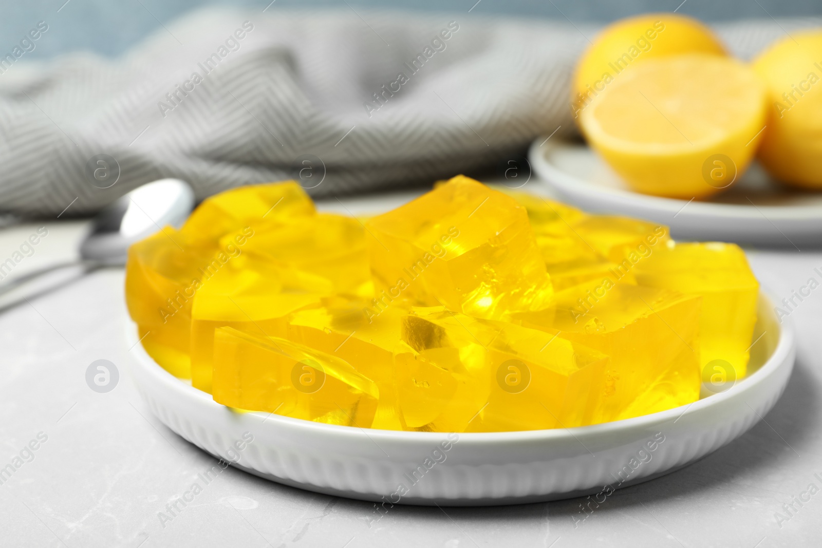 Photo of Plate with delicious lemon jelly on table, closeup