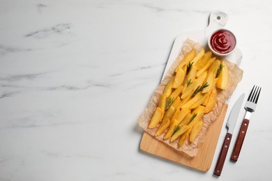 Photo of Tasty baked potato wedges, rosemary and sauce on white marble table, flat lay. Space for text