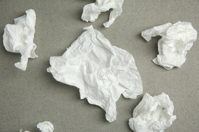 Photo of Used paper tissues on grey background, flat lay