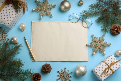 Photo of Flat lay composition with blank sheets of paper on light blue background, space for text. Writing letter to Santa