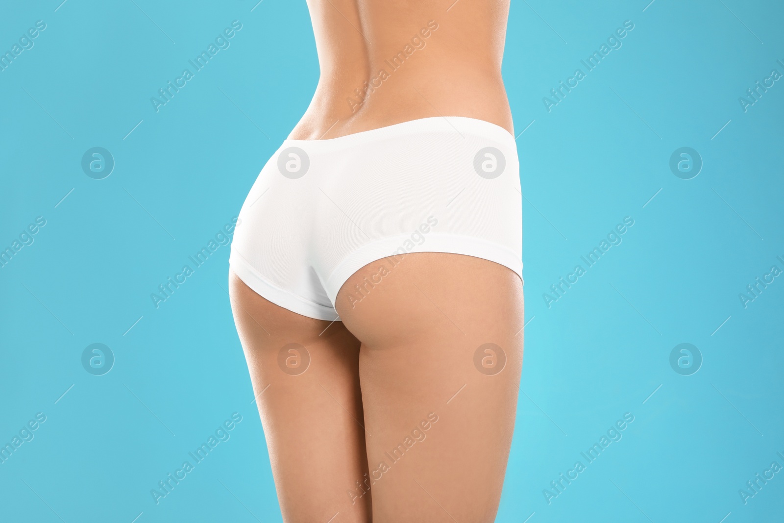 Photo of Slim young woman with smooth gentle skin on color background, closeup. Beauty and body care concept