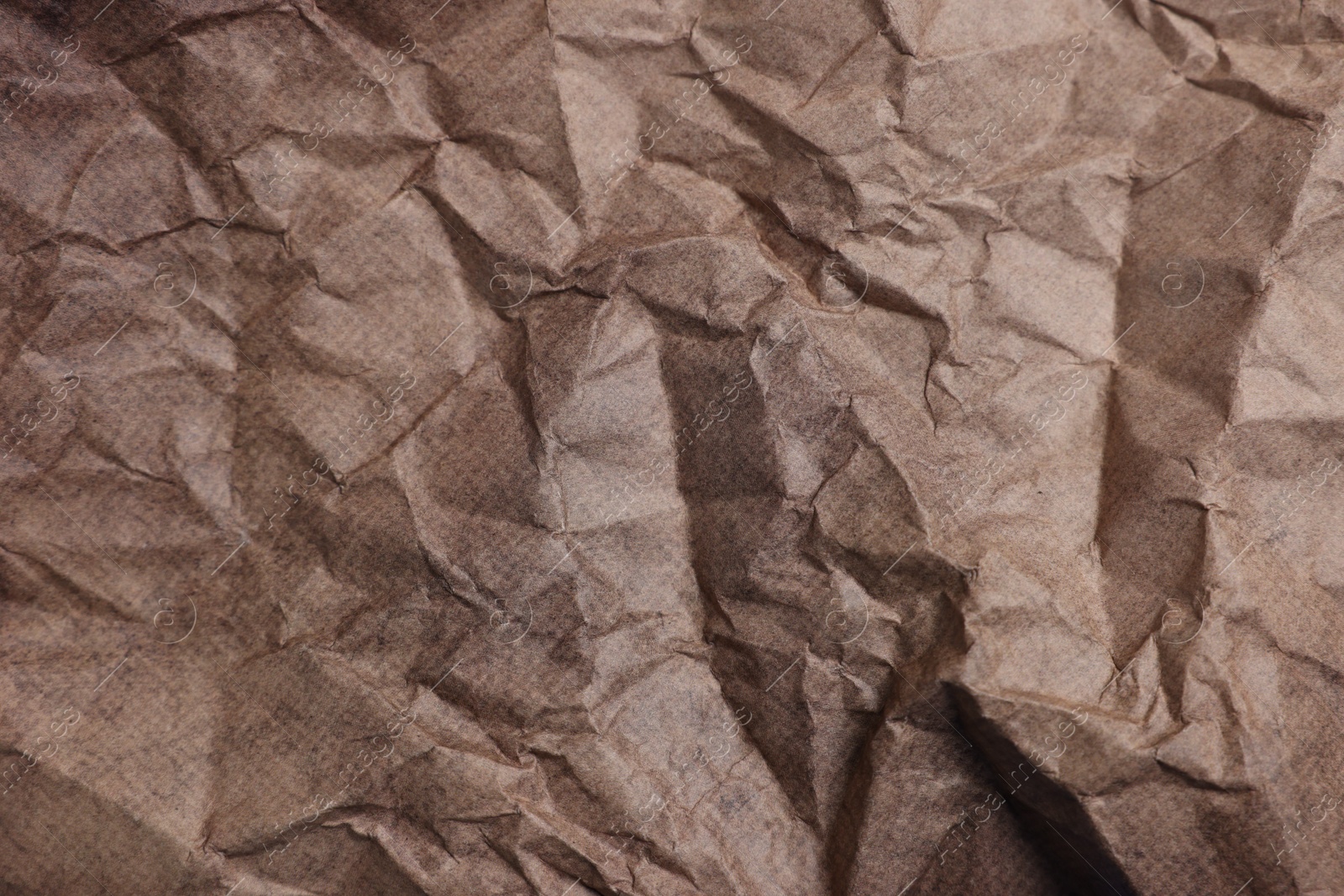 Photo of Texture of crumpled parchment paper as background, top view