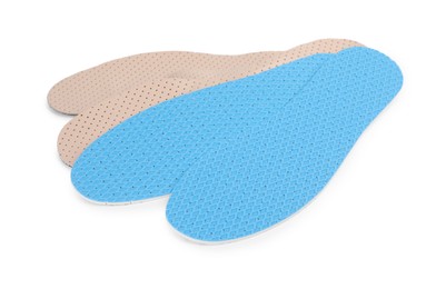 Photo of Two pairs of insoles on white background