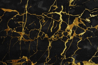 Image of Beautiful black and gold marble surface as background
