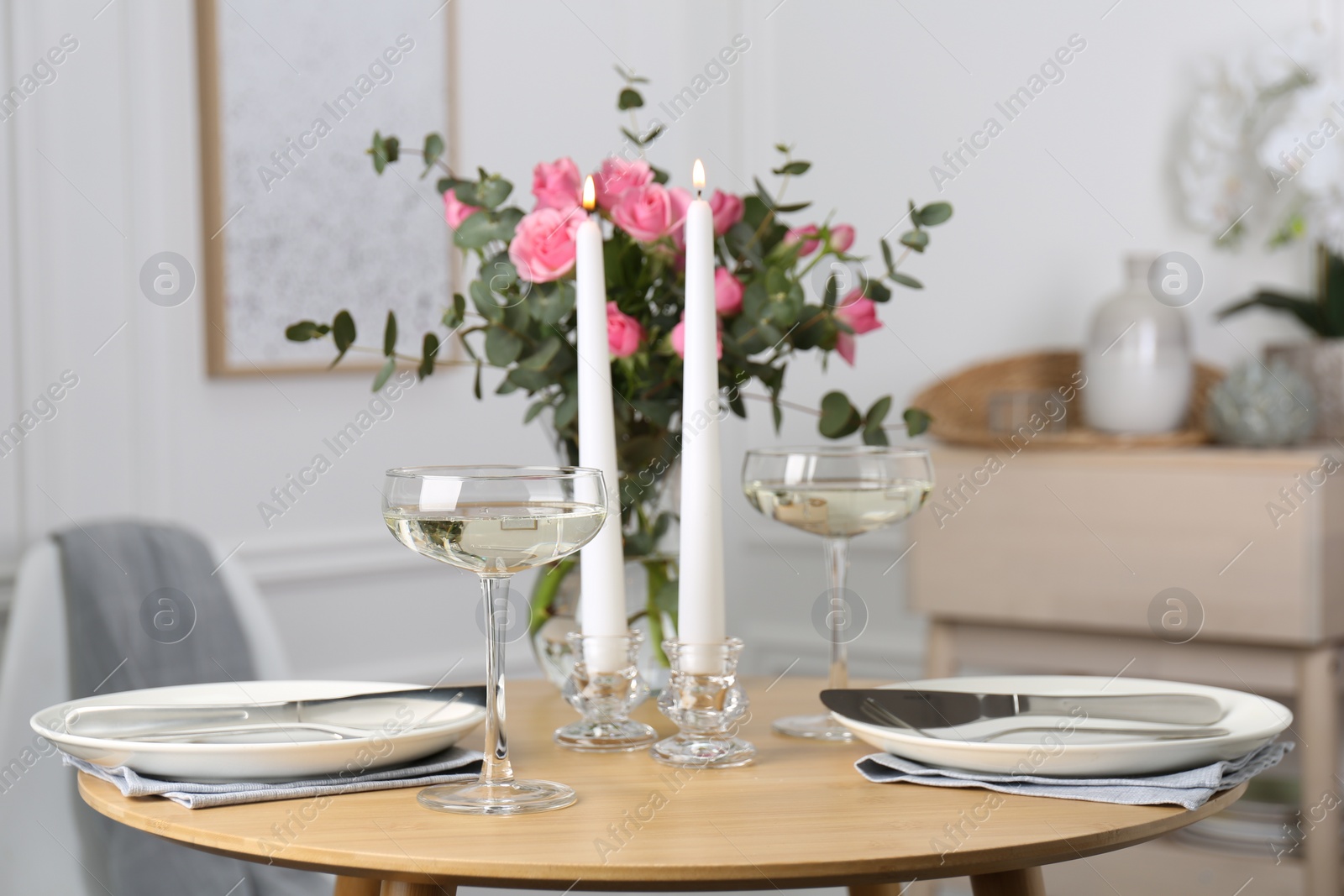 Photo of Romantic table setting with candles and flowers