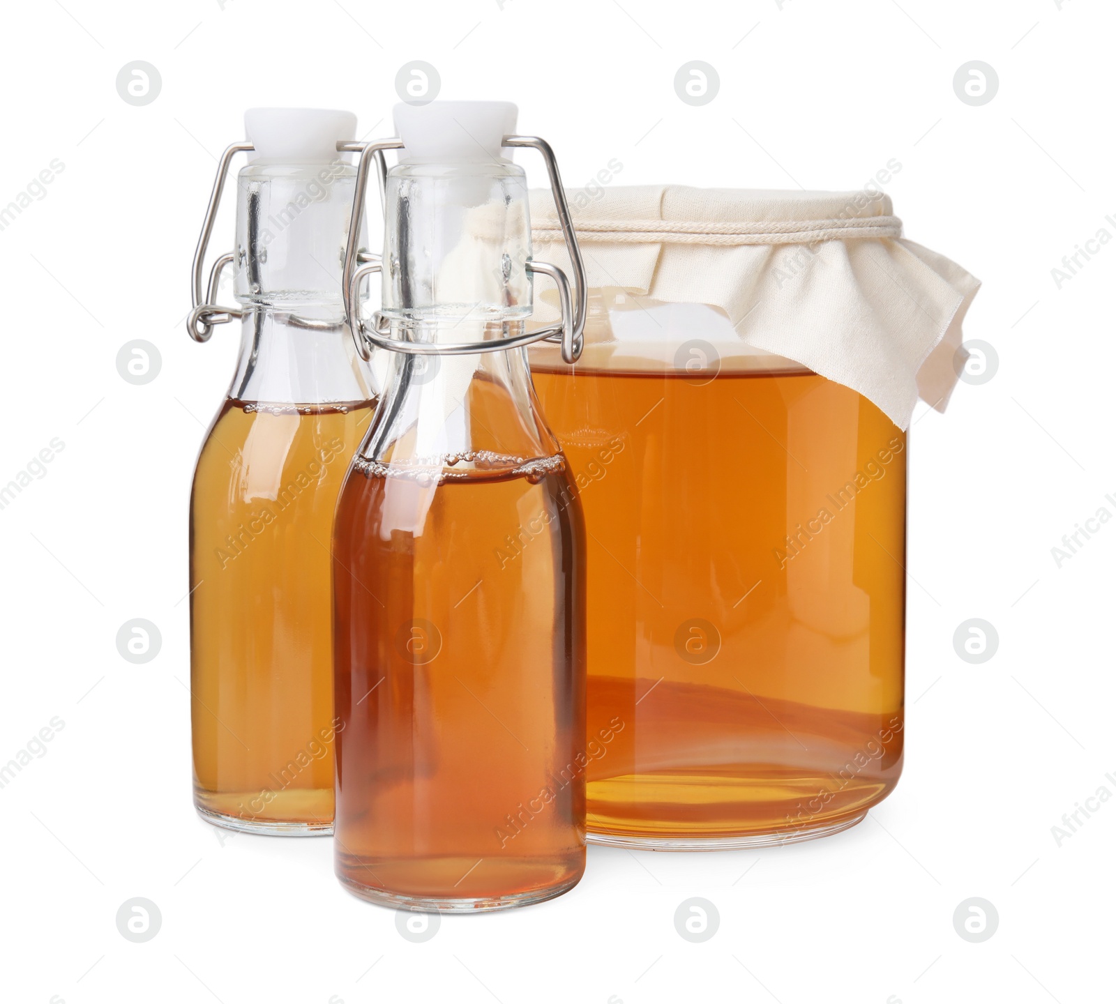 Photo of Tasty kombucha in glass jar and bottles isolated on white