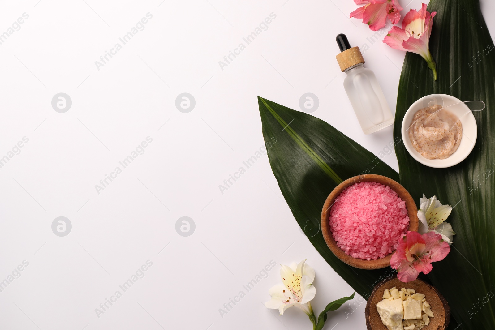 Photo of Flat lay composition with different spa products and beautiful flowers on white table. Space for text