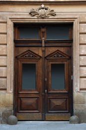 Photo of Entrance of house with beautiful wooden door, elegant molding and transom window