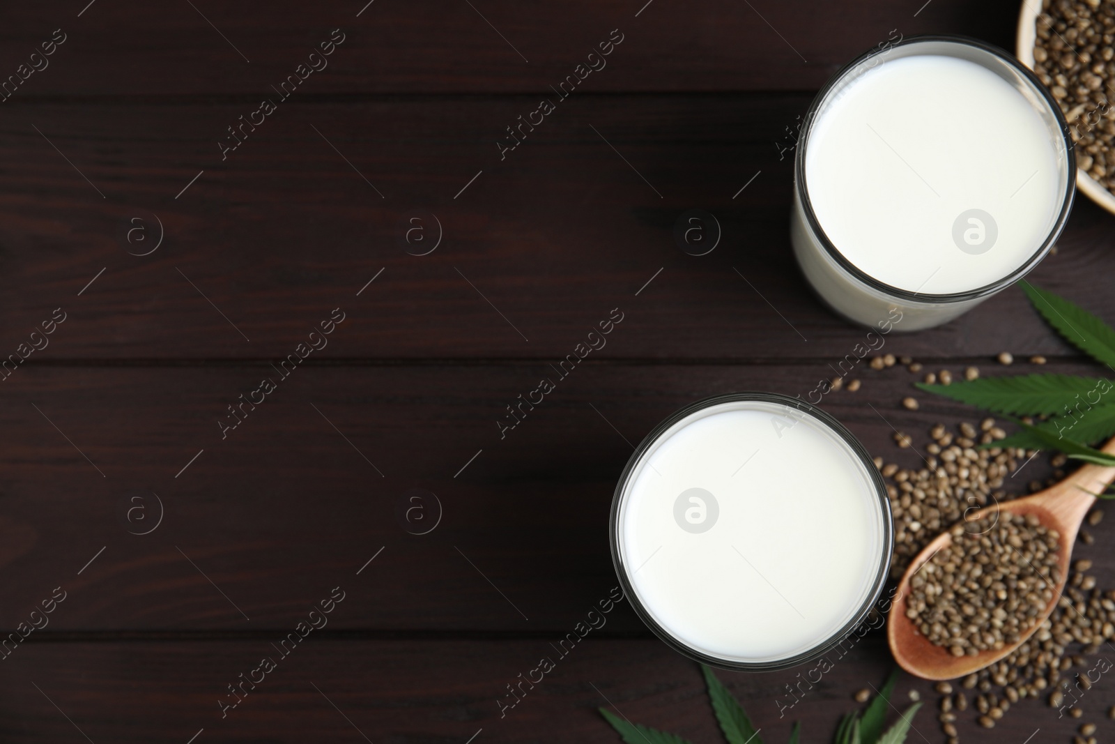 Photo of Flat lay composition with fresh hemp milk on wooden table. Space for text