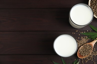 Flat lay composition with fresh hemp milk on wooden table. Space for text