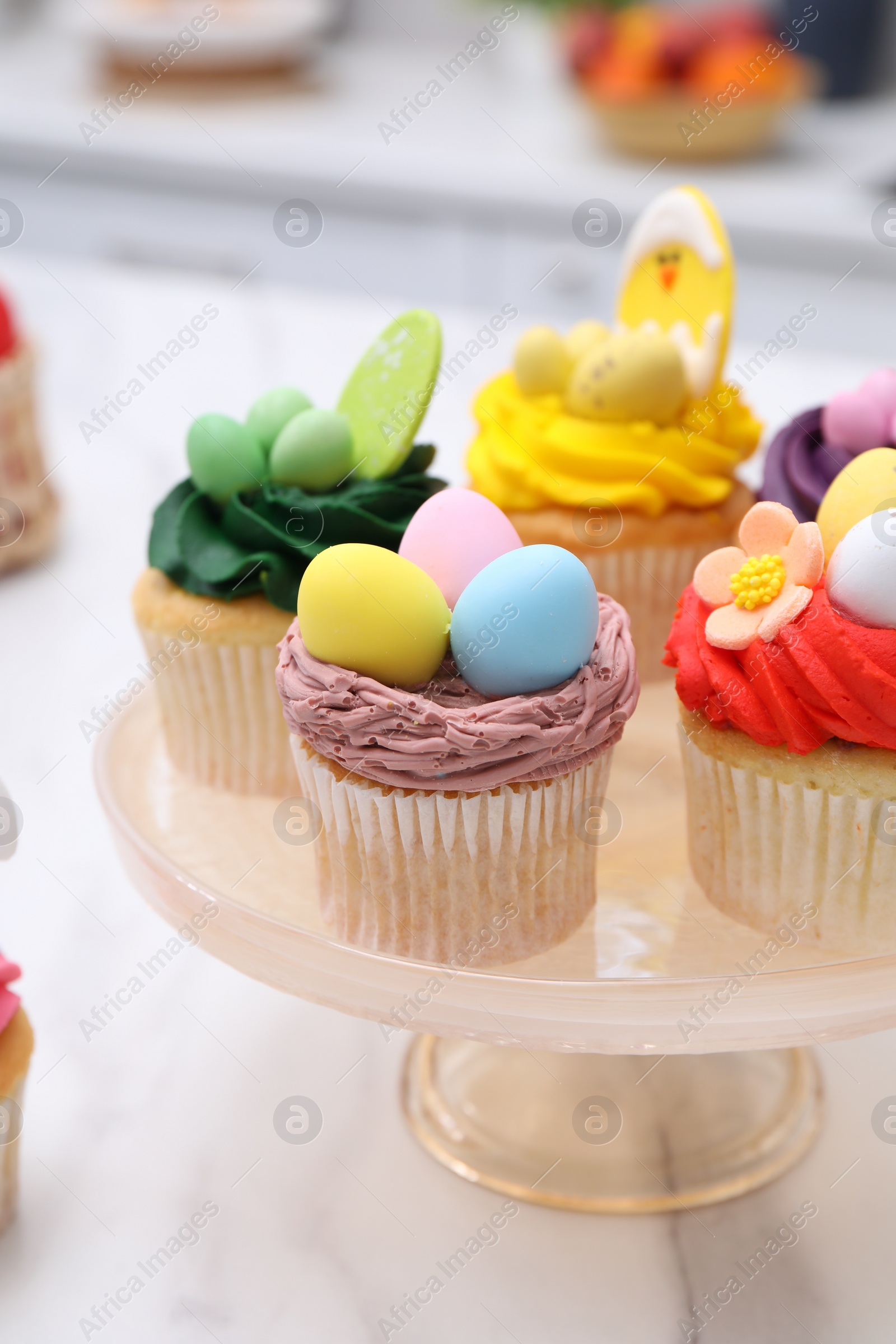 Photo of Tasty cupcakes with Easter decor on white marble table