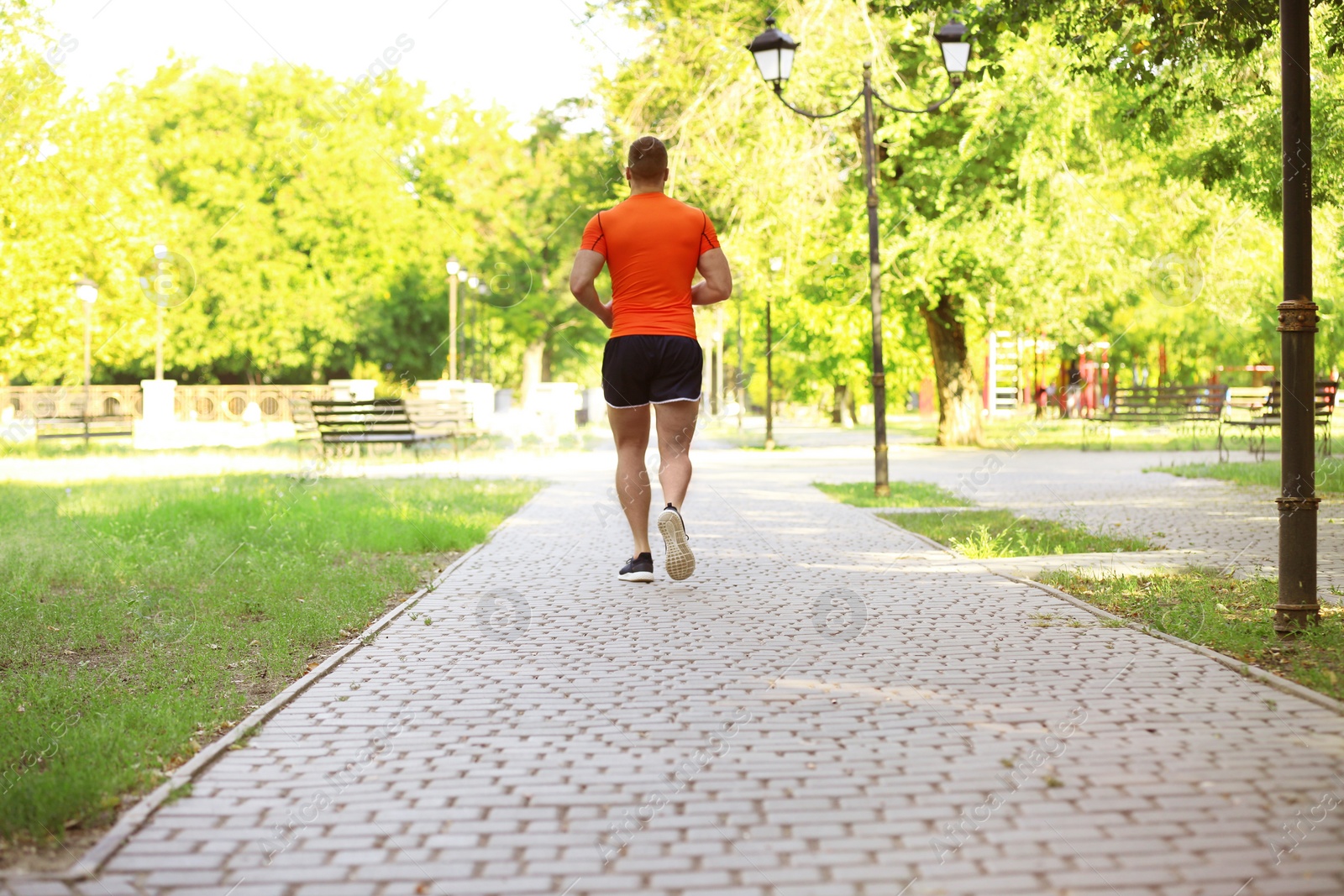 Photo of Young man running in park on sunny day