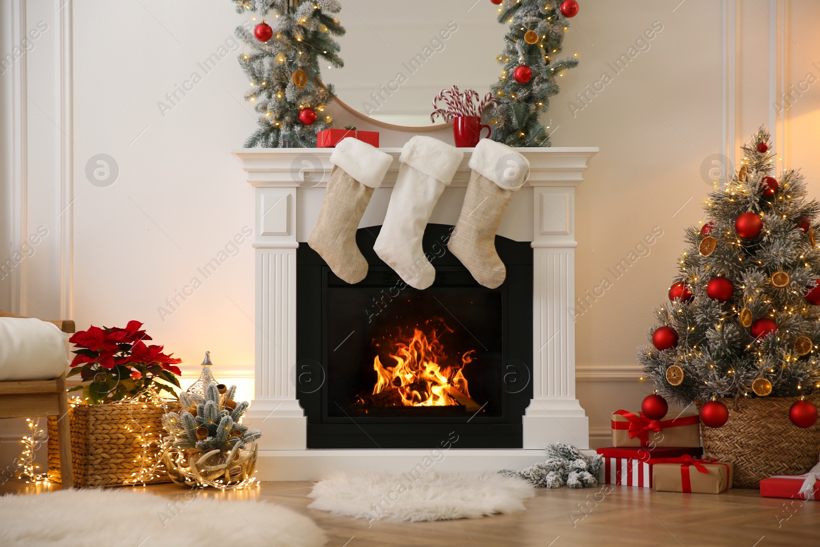 Photo of Fireplace with Christmas stockings in beautifully decorated living room