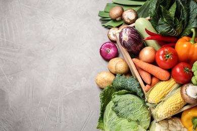 Photo of Flat lay composition with fresh vegetables on grey table, space for text