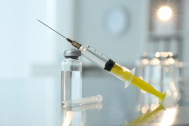 Syringe with vial of medicine on table