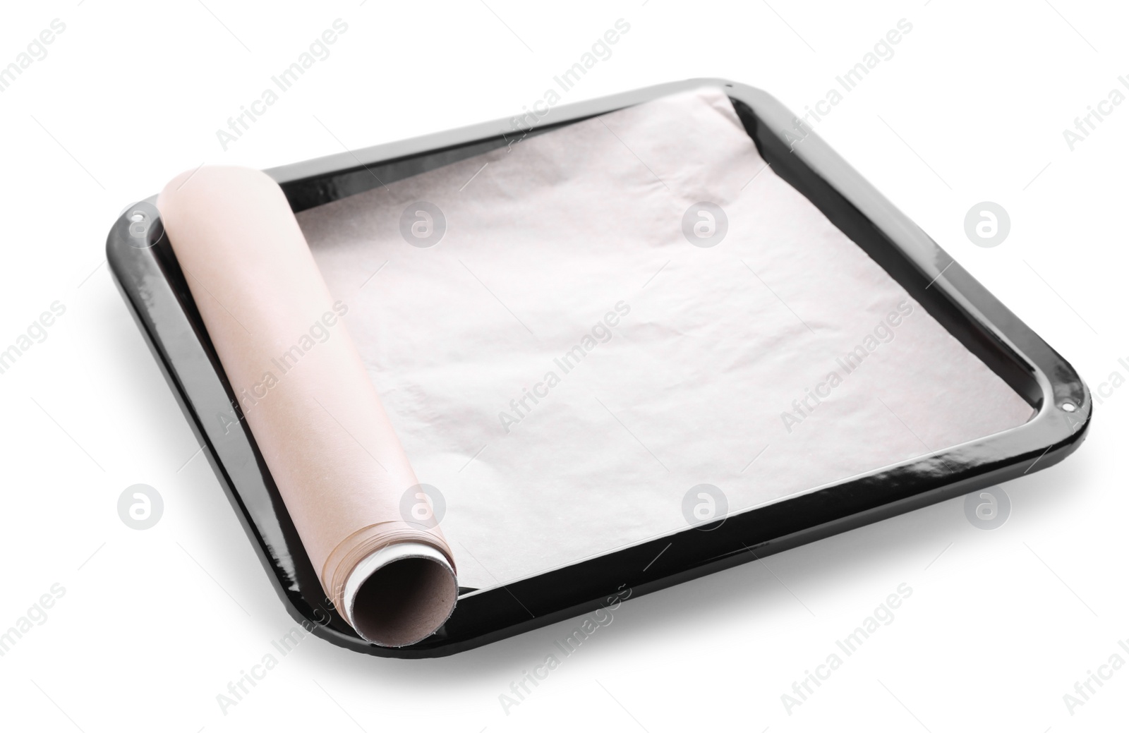 Photo of Baking pan with roll of parchment paper isolated on white