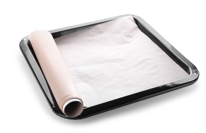 Photo of Baking pan with roll of parchment paper isolated on white