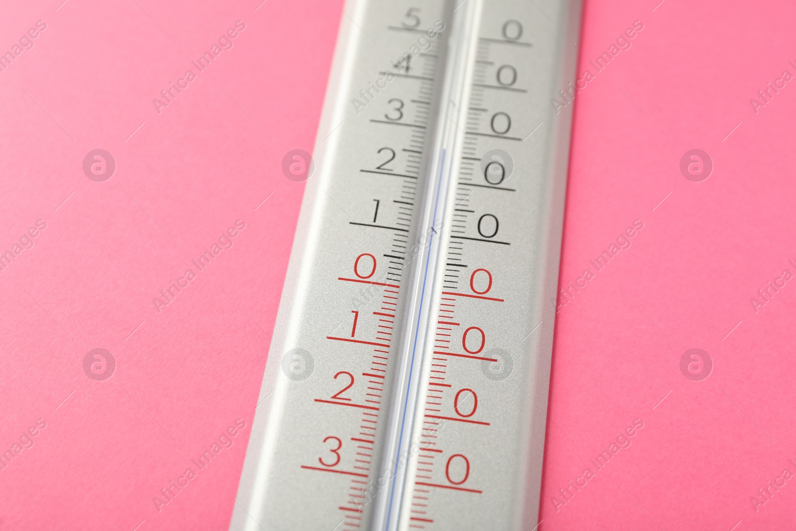 Photo of Modern weather thermometer on pink background, closeup