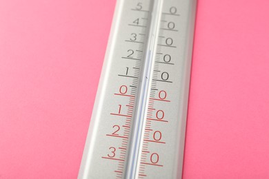 Photo of Modern weather thermometer on pink background, closeup