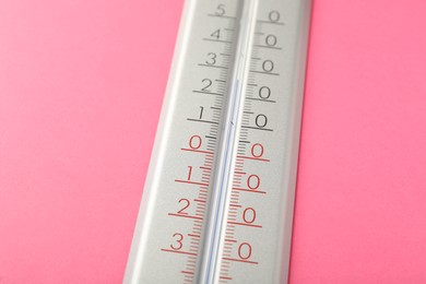 Modern weather thermometer on pink background, closeup