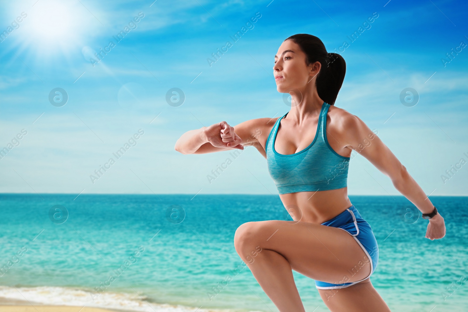 Image of Athletic young woman running near sea on sunny day, space for text 