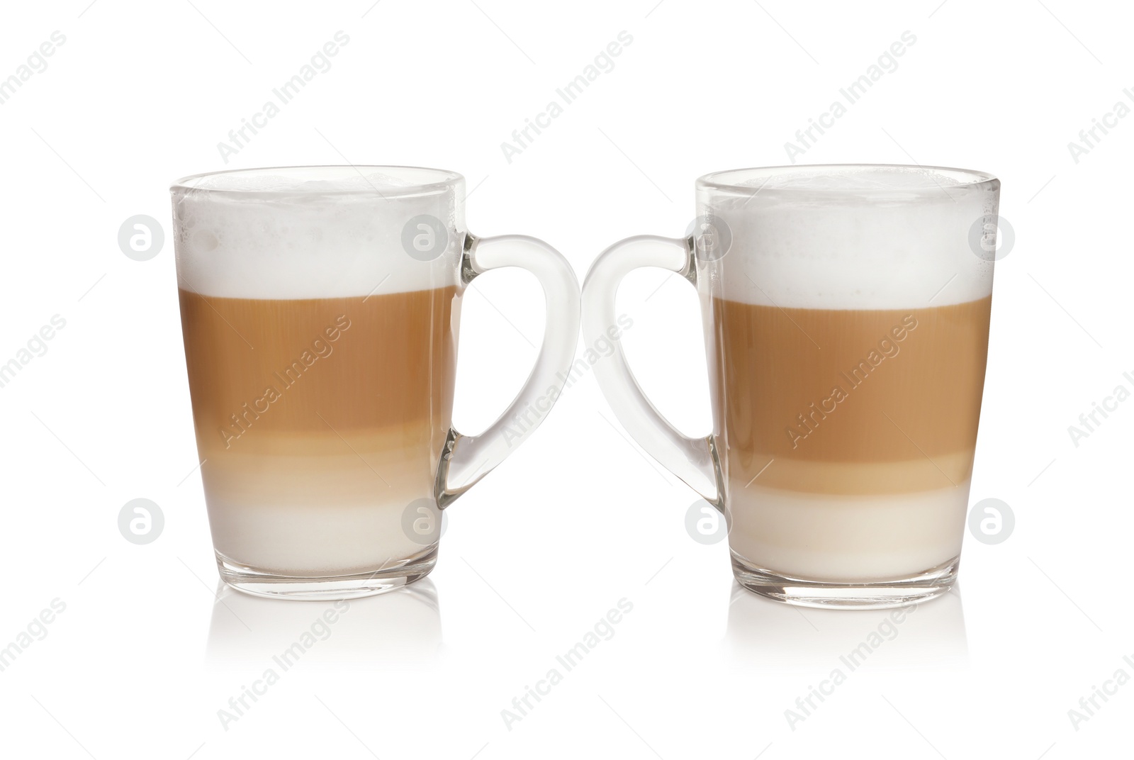 Photo of Hot coffee with milk in glass cups isolated on white