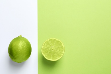 Flat lay composition with fresh limes on color background