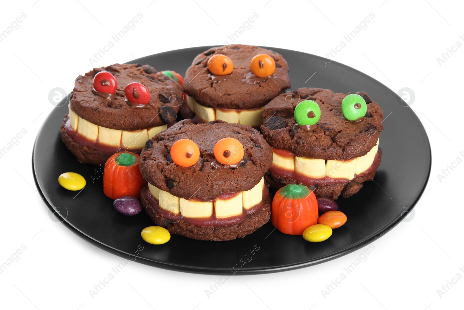 Photo of Delicious desserts decorated as monsters on white background. Halloween treat