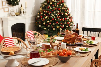 Photo of Festive dinner with delicious food and wine on table indoors. Christmas celebration