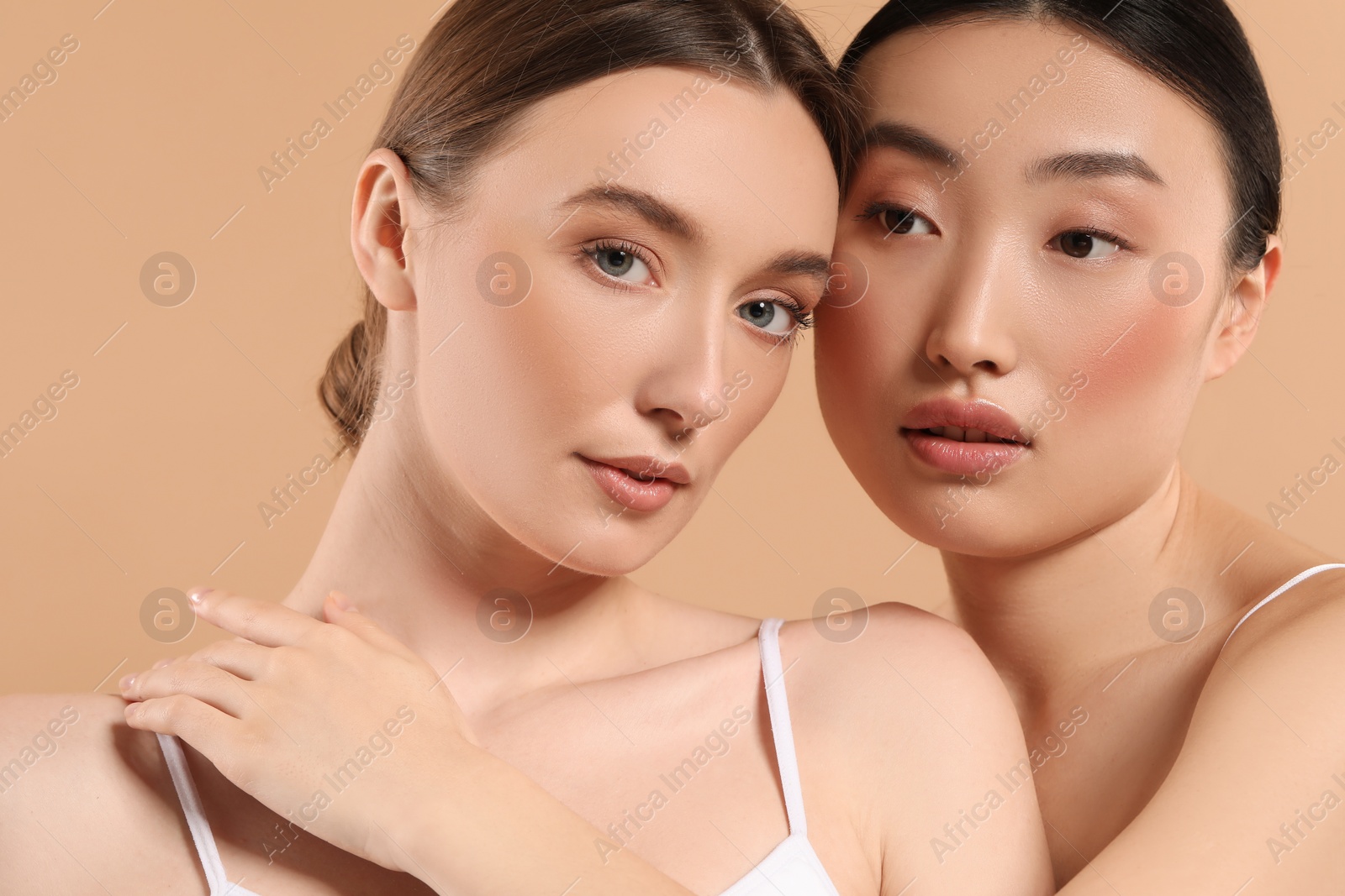 Photo of Beautiful young women with healthy skin on beige background