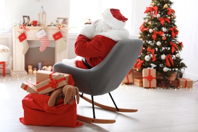 Authentic Santa Claus with bag of gifts indoors