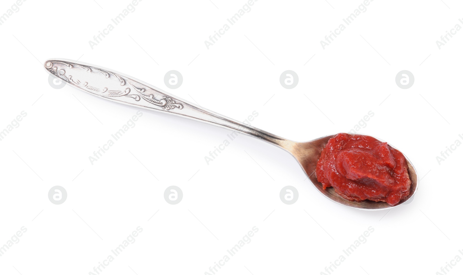 Photo of Spoon of tasty tomato paste isolated on white, top view