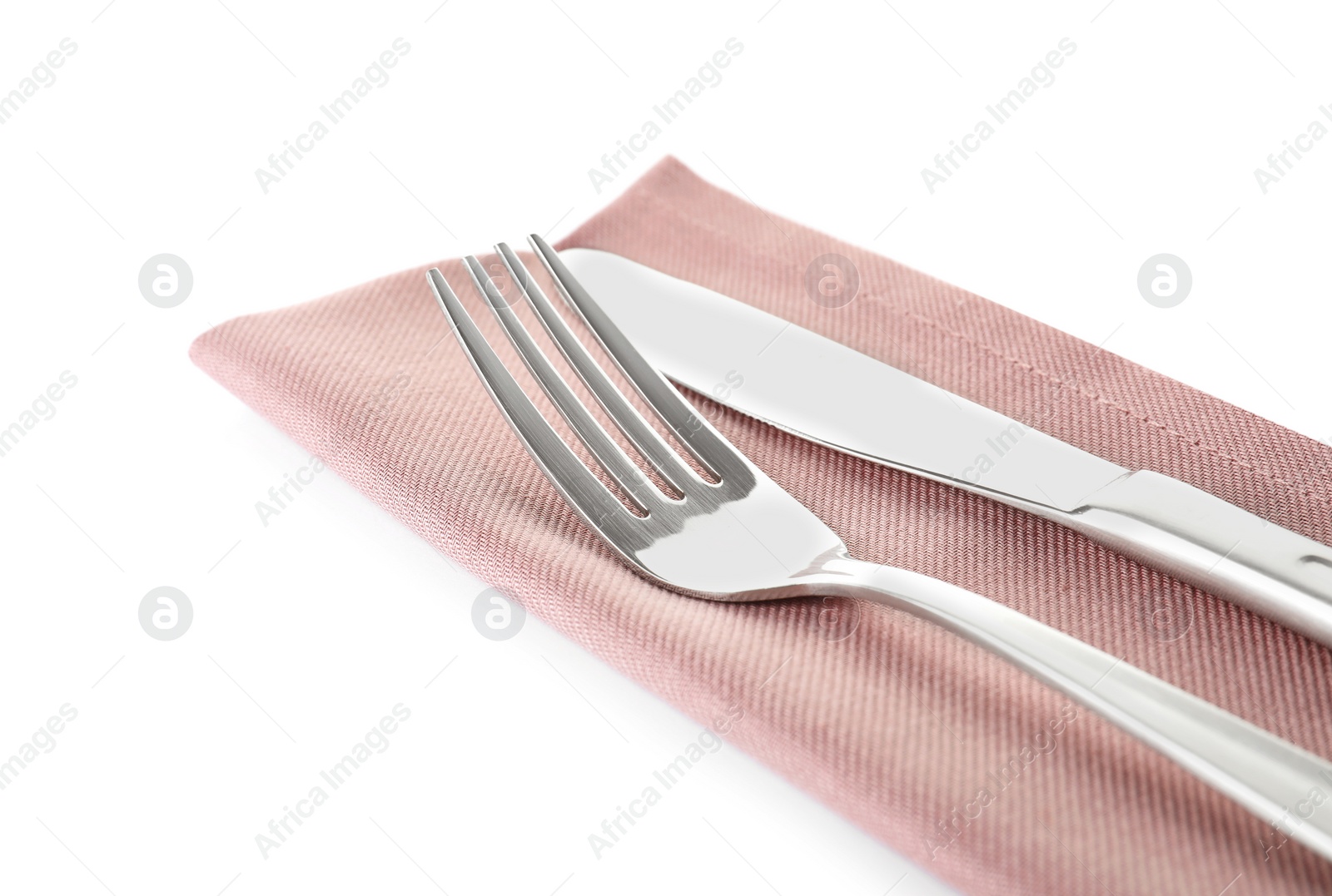 Photo of Fork, knife and linen napkin on white background, closeup