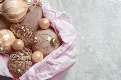 Collection of beautiful Christmas tree baubles on grey table, closeup