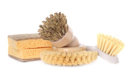 Photo of Cleaning supplies. Different brushes and sponges isolated on white