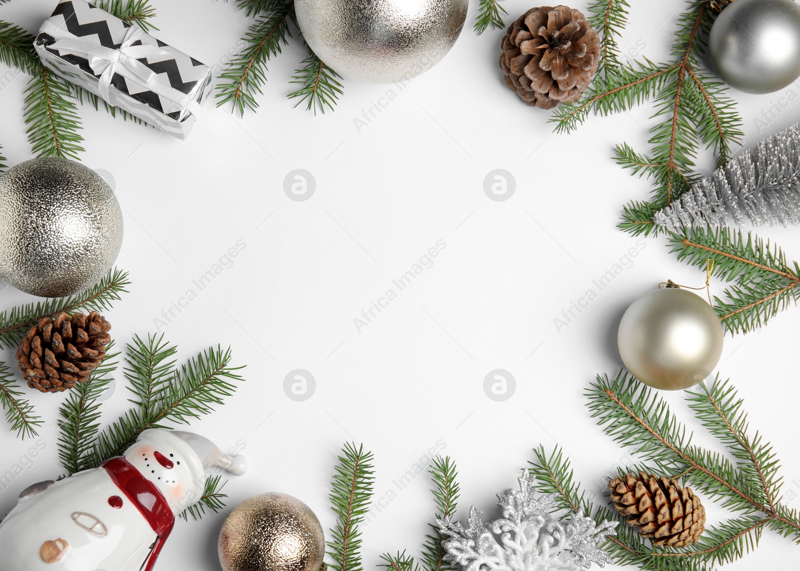 Photo of Christmas greeting card with space for text. Flat lay composition of fir tree branches and festive decor on white background