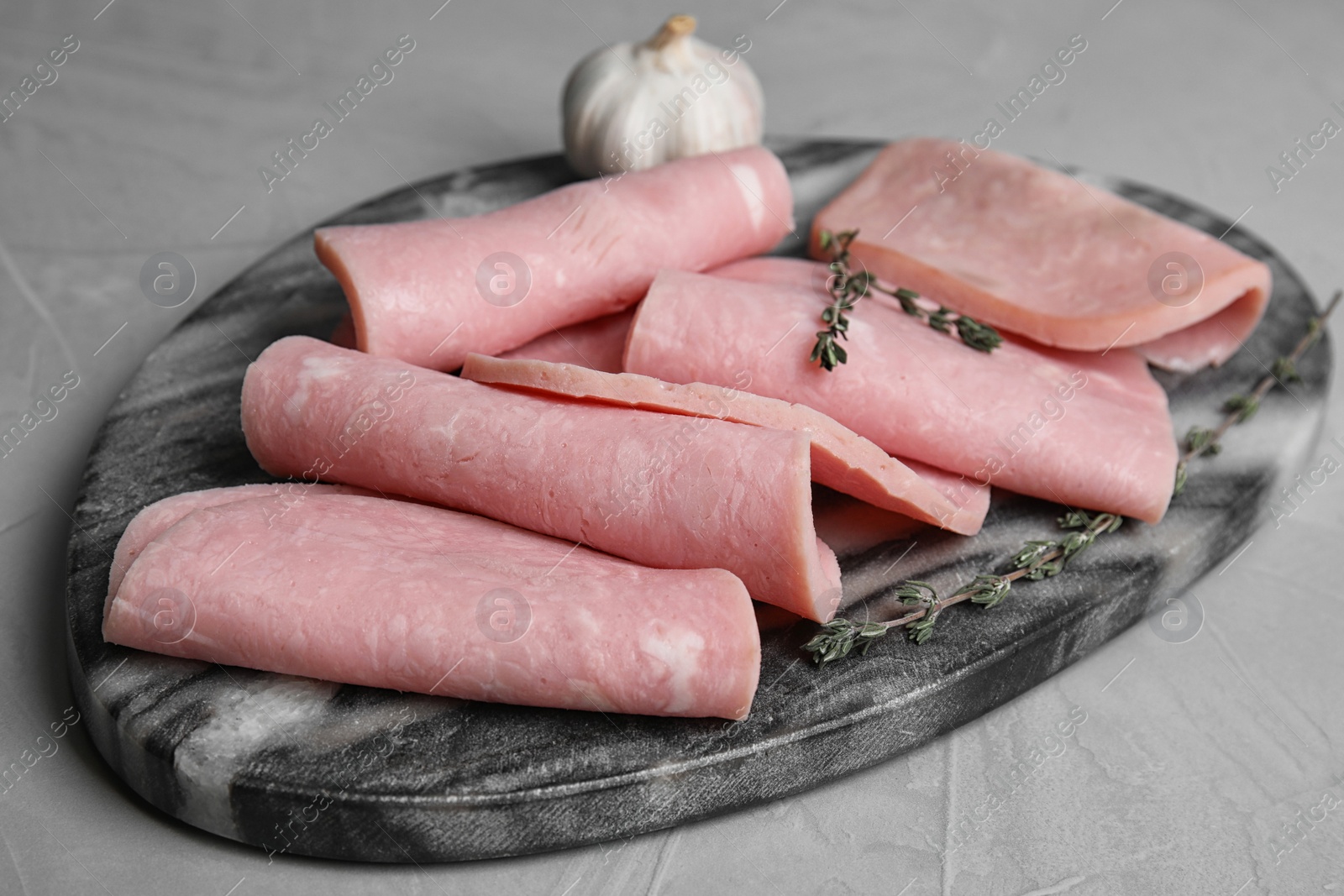 Photo of Tasty fresh ham served on light grey table
