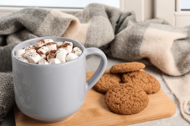 Photo of Composition with cup of cocoa and cookies on windowsill. Winter drink