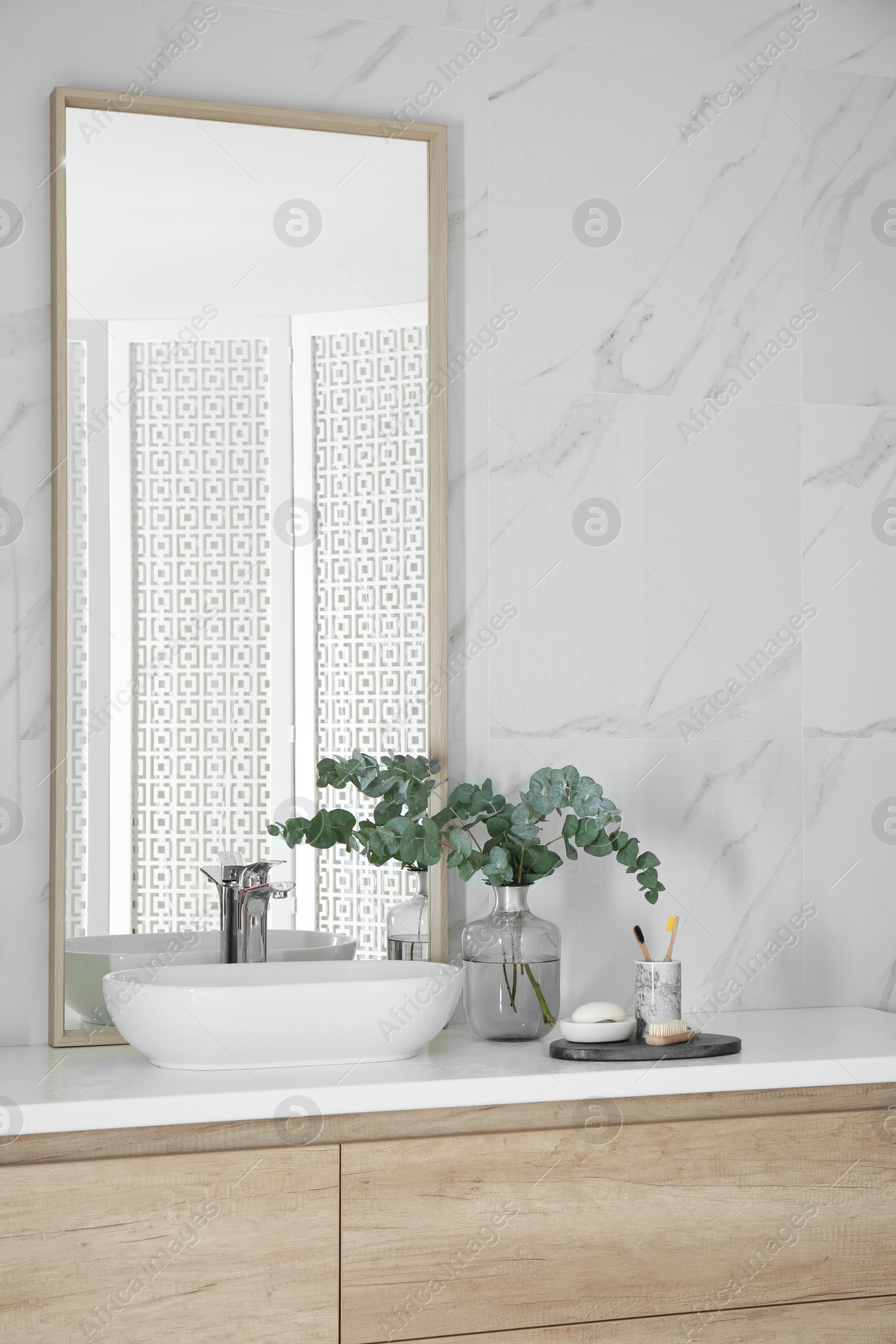 Photo of Modern bathroom interior with large mirror and vessel sink